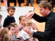 Ben Northey, MSO Patricia Riordan Associate Conductor Chair, passes the baton